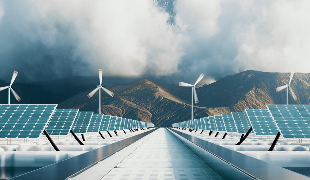 Array of solar panels and power generate windmills in from of a mountain.
